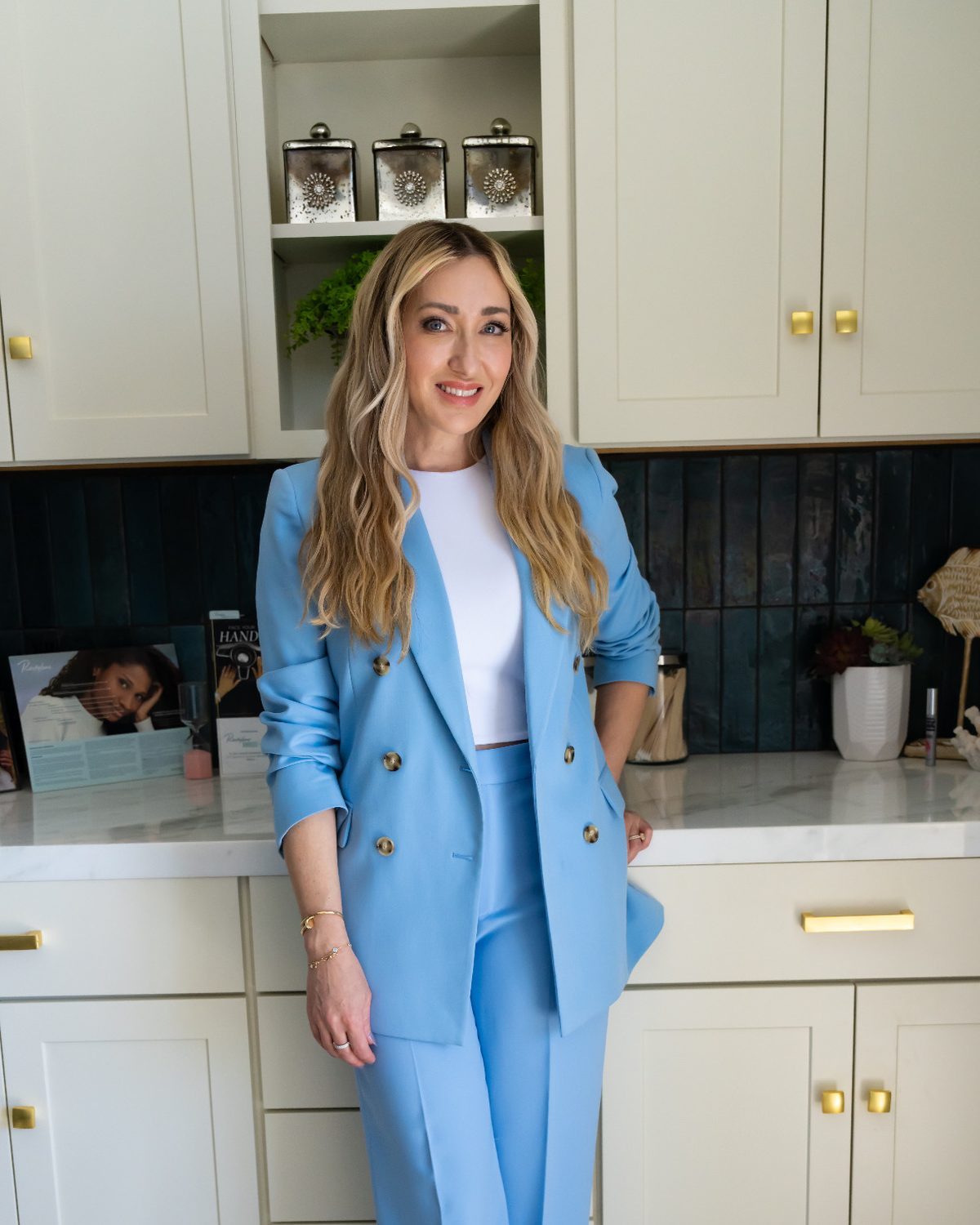 Nicole Smith, MSPA, in a light blue suit at HēBē Skin Health